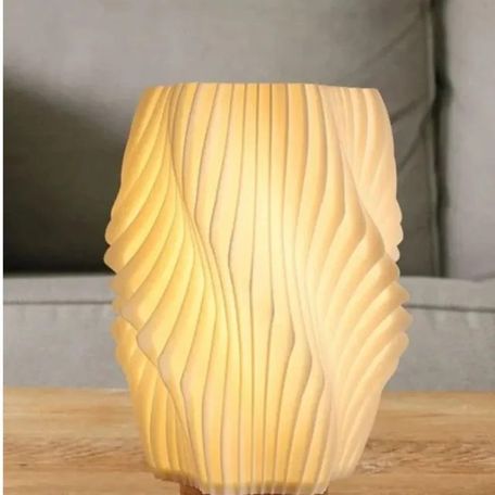 3D printed lamp shade glowing on a side table
