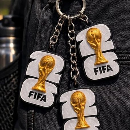 3D printed trophy keychains clipped to a backpack
